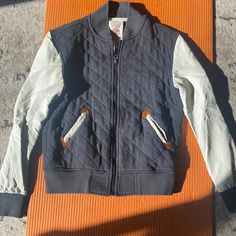 Form The Permanently Closed Who. A. U Brand, This Men’s Jacket Is Perfect For Fall Weather. With A Quilted Black Cotton Patterns In Front With Faux Leather Sleeves. Sleeves Are In Great Condition With No Cracking. Zipper Up. Some Brown At The Sleeve And Pocket Outlines. 2 Pockets In Front Casual Sports Outerwear With Patchwork, Sporty Quilted Outerwear For Streetwear, Winter Outdoor Varsity Jacket With Patchwork, White Sporty Quilted Outerwear, Sporty White Quilted Outerwear, Fall Sports Cotton Outerwear, Sporty White Outerwear With Padded Collar, Urban Varsity Jacket With Pockets For Outdoor, White Varsity Jacket For Outdoor Winter Activities