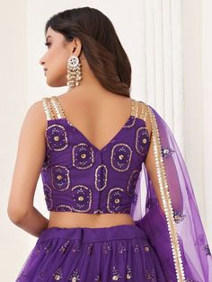 Let your elegance reflect and receive compliments with the stunning Pretty Purple Butterfly Net Lehenga Choli from Ethnic Plus. This exquisite lehenga choli in a beautiful purple color is made from high-quality butterfly net material.
Designed with a V shape neck, this party wear lehenga is sure to make you the center of attention at any occasion. The A-line silhouette flatters every body type, giving you an elegant and graceful appearance.
The lehenga comes semi-stitched and can be customized u Purple Dori Work Sharara For Diwali, Purple Organza Sets With Mirror Work, Purple Sharara With Dori Work For Diwali, Floor-length Purple Saree For Navratri, Purple Floor-length Saree For Navratri, Diwali Semi-stitched Net Choli, Purple Dori Work Blouse For Eid, Semi-stitched Purple Sharara With Self Design, Designer Purple Organza Sharara