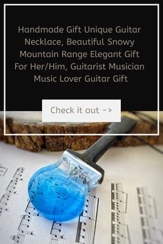 a blue glass with music notes on it and the words handmade gift unique guitar necklace, beautiful snow mountain range elegant gift for her / him