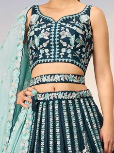 This stunning ensemble features a teal blue color satin lehenga with intricate sequin and coding thread embroidered work, paired with a matching satin choli adorned with the same exquisite details. The look is completed with a sky-blue georgette dupatta featuring a sequin work ethnic motif and embroidery cut work border.
The teal blue lehenga is semi-stitched up to 42 inches with a 3.0-meter flair, allowing for a perfect fit. The un-stitched choli material gives you the freedom to customize the Blue Palazzo Set With Unstitched Blouse For Diwali, Blue Palazzo Set With Intricate Embroidery For Diwali, Blue Embroidered Palazzo Set For Diwali, Blue Palazzo Set With Unstitched Blouse For Reception, Blue Fitted Palazzo Set With Intricate Embroidery, Fitted Blue Palazzo Set With Intricate Embroidery, Blue Choli With Zari Work In Chinon, Blue Anarkali Palazzo Set With Intricate Embroidery, Designer Turquoise Sets With Resham Embroidery