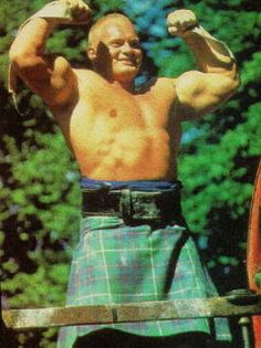 a man in a kilt flexing his muscles