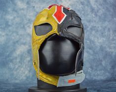 a yellow and red mask on top of a black head