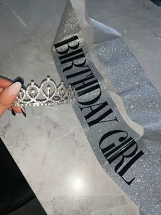 someone is holding up a tiara with the words happy birthday and crown on it