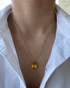 Crafted in 18k gold plated brass, this captivating pendant features a pear-shaped simulated citrine stone that radiates brilliant, sparkling light.  Comes with a 16in chain that includes a 2in extension. ✥ Also available with a clear stone:     https://www.etsy.com/listing/1385440930/aura-teardrop-pendant-necklace-18k-gold Perfect to be used at girls night out, date night, the kid's school carpool lane or your next zoom meeting!  Perfect for a gift or a special little treat for yourself. ITEM DESCRIPTION ♥ Pear shaped pendant necklace ♥ Color: 18k Yellow Gold ♥ Necklace Length: 16+2 in chain necklace ♥ Pendant Size: 15*9 mm ♥ Stone: High Quality Cubic Zirconia (citrine color) ♥ Material: 18k Gold Plated Brass ♥ Sold individually ABOUT OUR ZIRCON ♡ As brilliant as a natural diamond ♡ Best s Citrine Necklace Simple, Teardrop Topaz Necklace For Gift, Pear-shaped Citrine Jewelry For Gifts, Pear-shaped Orange Jewelry Gift, Orange Pear-shaped Jewelry For Gifts, Orange Pear-shaped Jewelry, Gold Drop Necklace With Birthstone, Gold Birthstone Drop Necklace, Pear-shaped Gemstone Drop Necklace In Yellow Gold