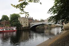 a bridge over a river with boats on it