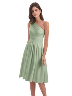 a woman wearing a green bridesmaid dress with one shoulder and pleaed skirt