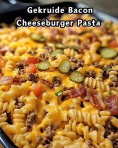 a casserole dish with cheeseburger pasta and pickles