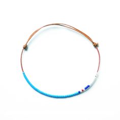 The bracelet is handmade. Small cylindrical glass beads (1,6mm) threaded by hand, one at a time, onto the precisly fitting thread. The thread is a finely woven, waxed cotton twine. The colors assigned to each bracelet are a free interpretation between those of the national flag and the colors of the sports teams jerseys. We recommend to verify the measure of the wrist. Blue Handwoven Bracelets For Beach, Adjustable Ocean-colored Beaded Bracelets For Gifts, Adjustable Woven Blue Bracelets, Adjustable Blue Ocean-inspired Bracelet, Turquoise Hand-strung Braided Bracelet For Beach, Cotton Bracelet, Lava Bracelet, Thread Bracelets, A Bracelet