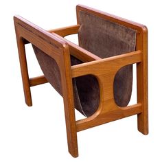 a wooden chair with two leather seats on it's back and one arm folded up