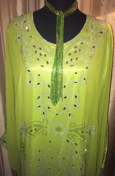 Beautiful Bling Gown.  One size fits most.  There are 2 ties inside of gown to allow for better form fit. Beautiful Chartreuse Gown Length: Between 56 to 60 inches long. Recommended Washing Instruction: - For best results dry clean or hand wash and line dry - No bleach In stock and READY TO SHIP!  Products are created in a SMOKE-FREE, PET-FREE environment. Material: 100% silk If you have any questions about the colors, size, feel free to contact me.  Please note: Due to hygiene reasons, RETURNS, REFUNDS, or EXCHANGES CANNOT BE ACCEPTED.  While I do not accept returns, if you have an issue with an item you have received, please make sure to contact me through the shop, and I'll be happy to help sort out a solution for you. Become a fan of my Facebook page: https://www.facebook.com/PreciousP Long Green Kaftan For Wedding, Green Long Party Abaya, Green Maxi Length Kaftan For Wedding, Elegant Green Spring Abaya, Green Long Abaya For Party, Elegant Green Evening Abaya, Elegant Evening Green Abaya, Summer Wedding Floor-length Abaya, Green Floor-length Party Kaftan