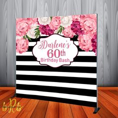 a black and white striped birthday backdrop with pink flowers on the front, along with an 80th birthday bash sign