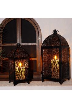 two decorative lanterns sitting next to each other