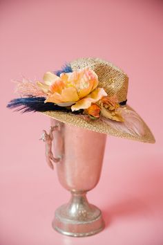 Stay ahead of the pack with THE FRONT RUNNER SUN HAT! The derby style will make you feel like a real winner while the navy feather and orange flower add a pop of color. Keep cool and fashionable with this must-have accessory. This hat is ONE OF A KIND, created by our owner Stephanie. To receive item quicker, expedited shipping is available at checkout. Feathered Brimmed Hat Bands For Summer, Brimmed Hat Bands With Feathers For Summer, Summer Brimmed Hat With Feathers, Summer Mini Hat With Feathers And Short Brim, Summer Mini Hats With Feathers And Curved Brim, Summer Mini Hat With Curved Brim And Feathers, Summer Garden Party Hats With Feathers, Summer Wide Brim Mini Hats With Feathers, Summer Costume Hats With Feathers And Short Brim