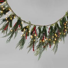 a christmas garland with lights and evergreen leaves