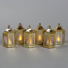 five small gold lanterns sitting next to each other