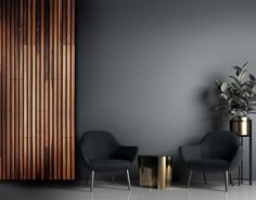 two chairs and a table in front of a wall with wood slats on it