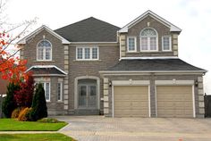 a large house with two car garages in front of it