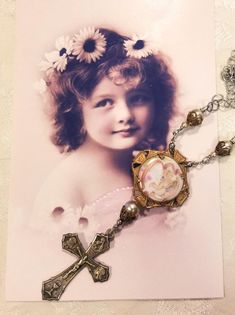 "I love this sweet mixed metal cross necklace. The angel / cherub is a very old vintage porcelain button set in a vintage setting. I found the ITALY cross at a Rome flea market.  They are connected with Swarovski pearls and filigree to create this striking 3 3/4\" long pendant. The antiqued silvertone chain strand hooks on the side and is 15 1/2\" long. If you need a different length please let me know. Our new vintage jewelry makes a great gift for Christmas, a birthday or an anniversary....or Victorian Jewelry With Miraculous Medal For Gifts, Vintage White Cross Jewelry, Vintage Crucifix Necklace With Miraculous Medal, Vintage Nickel-free Crucifix Necklace, Antique Crucifix Necklace Gift, Antique Cross Necklace For Gift, Antique Crucifix Jewelry Gift, Antique Crucifix Necklace For Gift, Antique Crucifix Necklace As A Gift