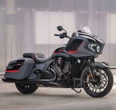 a black and red motorcycle parked in front of a building