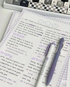 a pen sitting on top of a paper next to a keyboard