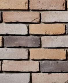 a brick wall made out of several different colored bricks