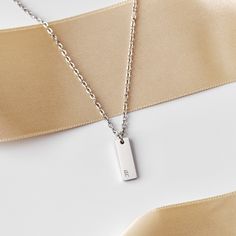 Our tiny personalized rectangle initial necklace is beautiful & perfect for anyone! The rectangle pendant is so dainty, which makes it great for layering, or just everyday wear.❤︎ * * * * * * * * * * * * * * * * * * * * * * * * * * * * * * * * * * * * * * * * * * * * D E T A I L S * All products are handmade. * Materials: 316L Stainless Steel * Chain style: Cable * Pendant: 15 mm X 5 mm * Color: Silver * Make: As shown in picture * Personalization Available * Made to Order * * * * * * * * * * * * * * * * * * * * * * * * * * * * * * * * * * * * * * * * * * * * H O W ∙ T O ∙ O R D E R * Just use the 'PERSONALIZATION BOX' to let us know the engravings and FONT OPTION you would like have on the charm. * The maximum number of characters allowed is 5. (Space, Number and Symbol are all considered Rectangle Pendant, Initial Pendant Necklace, Engraved Necklace, Initial Pendant, Steel Chain, Stainless Steel Chain, Initial Necklace, Jewelry Plate, Chain Styles