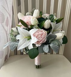 a bridal bouquet sitting on top of a chair