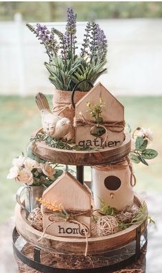 three tiered birdhouse planter made out of wood with lavenders and greenery