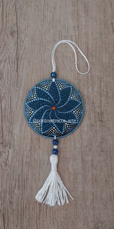 a blue and white decoration hanging on a wooden surface