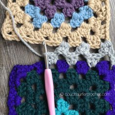 a crocheted granny's square with a knitting needle