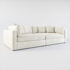 a white couch with several pillows on it