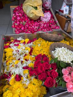 flowers are laid out on the ground for sale