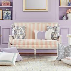 a living room filled with furniture and purple walls