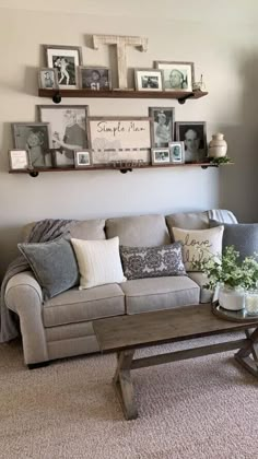 a living room filled with lots of furniture and pictures on the wall above it's coffee table