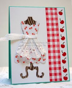 a card with an apron and checkered table cloth on it, the paper is made from