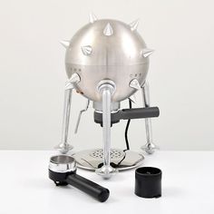 an unusual looking coffee maker with horns on it's head