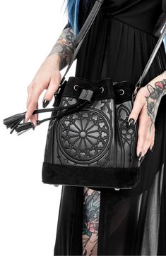 Embrace your inner goth with our goth black sanctum bucket bag. crafted with meticulous attention to detail, this bag seamlessly combines dark aesthetics with practicality. perfect for carrying your essentials, it exudes an aura of mystery and elegance that will make heads turn wherever you go Luxury Bucket Bag With Metal Details, Cheap Punk Halloween Bags, Punk Style Halloween Bags, Cheap Black Alternative Style Bags, Luxury Travel Bucket Bag With Leather Lining, Cheap Alternative Black Bags, Cheap Gothic Bags For Halloween, Affordable Gothic Halloween Bags, Window Embroidery