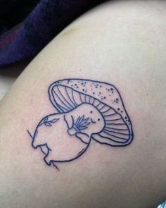 a small mushroom tattoo on the thigh