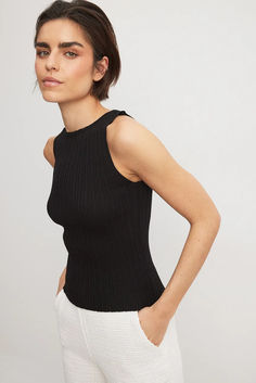 Fine Knitted Sleeveless Top Black Sleeveless Top With Ribbed Neckline, Chic Ribbed Crew Neck Tank Top, Chic Stretch Tank Top With Ribbed Neckline, Chic Black Tank Top With Ribbed Neckline, Black Ribbed Stretch Sweater Vest, Black Stretch Ribbed Sweater Vest, Elegant Stretch Crew Neck Tank Top, Elegant Crew Neck Stretch Tank Top, Elegant Stretch Tank Top With Crew Neck