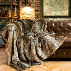 a brown leather couch covered in faux fur