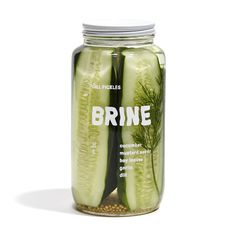 a jar filled with cucumber slices sitting on top of a table