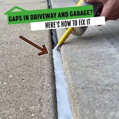 a man is painting the side of a curb with yellow paint and a green arrow pointing to it