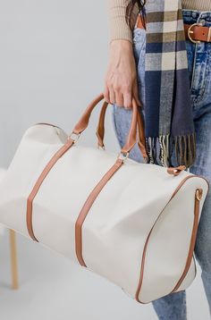 This is the swaggiest overnight duffle there is! PU Leather duffle featuring contrasting handles, cross body strap, large storage compartment with an inner zipper pouch for all your personal items. Let's go on a trip! In White/Tan, White/Black, and Burgundy. HD3006 Travel Duffle Bag Aesthetic, Travel Duffle Bag Women, Anarchy Symbol, Catching Flights, Utility Tote Bag, Large Utility Tote, Utility Tote, Leather Duffle, Duffle Bag Travel