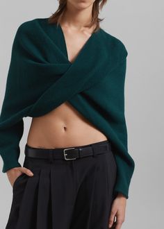 Color: Emerald Midweight knit fabric Highly cropped profile V-neckline Twist detail at front Slip on style Unlined 70% Wool 25% Polyamide 5% Other Fibres Hand Wash or Dry Clean By Beaufille. Made in Italy Green V-neck Crop Top For Fall, Cropped Winter Shrug, Elegant Green Cropped Crop Top, Elegant Cropped Knit Sweater, Elegant Knit Cropped Top, Elegant V-neck Crop Top For Fall, Elegant V-neck Cropped Sweater For Winter, Paris Store, Denim Suit