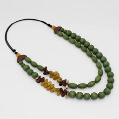 Immerse yourself in the beauty of nature with the Verde Forrest Necklace. Featuring handcrafted wooden elements in a rich, vibrant green, reminiscent of lush forests and serene meadows. The necklace combines the organic texture of wood with a polished finish, creating a harmonious blend of natural beauty and contemporary design. Wood, waxed cord Adjustable Length: 24"-34" Made in Philippines Style # BP24N43 Green Wood Bead Necklace, Texture Of Wood, Design Wood, Necklace Green, Green Necklace, Vibrant Green, The Beauty, Philippines, Contemporary Design