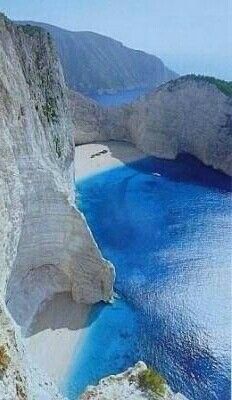 an aerial view of the blue waters and cliffs