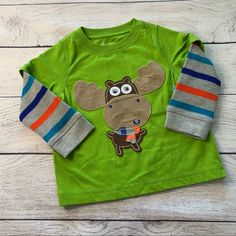 New With Tags! Nursery Rhyme Long Sleeve Tee Size 18 Months Moose Applique Design With Googly Eyes That Move Striped Waffle Night Long Sleeves 60% Cotton 40% Polyester Smoke Free Pet Friendly Home Fun Long Sleeve T-shirt For Playtime, Green Long Sleeve Cartoon Print Top, Green Long Sleeve Top With Cartoon Print, Playful Green Long Sleeve T-shirt, Green Playful Playwear Tops, Playful Green Playwear Tops, Cute Green T-shirt For Playwear, Playful Green Tops For Playwear, Fun Cotton Tops For Playtime