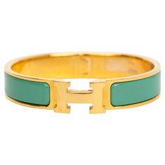 The Hermes new Clic clac H, narrow bracelet, in vert moderne enamel with gold-plated hardware. Size PM, new in unworn condition, comes with velvet pouch. Hermes Bracelet, Teal And Gold, Green And Gold, Arm Band, Jewelry Bracelets, Pouch, Bracelet, Green, Gold