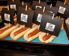 there are many hot dogs with pirate flags on them