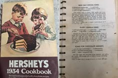 an old recipe book is opened to show two children cutting a piece of chocolate cake